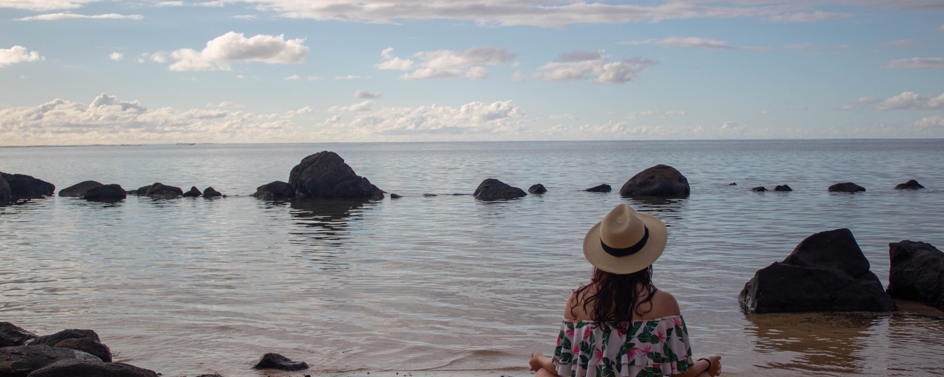 Finding a moment of peace while meditating to the sound of the gentle waves in Hawaii.