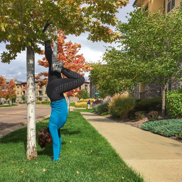 Practicing handstands outside.