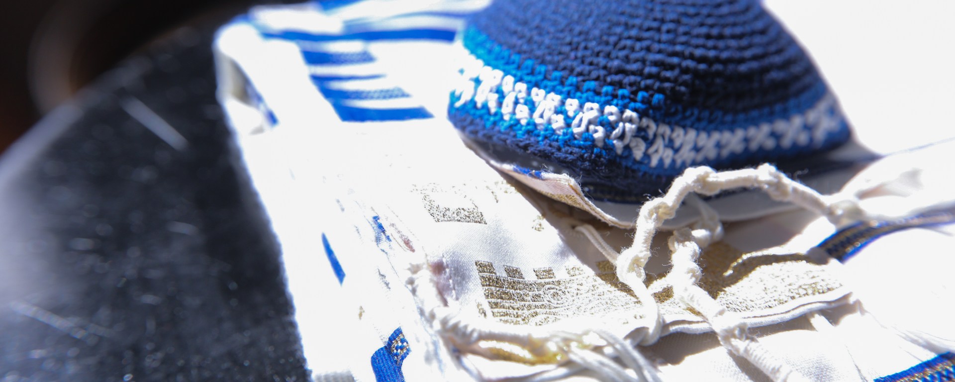 Kippah resting on a tallit.